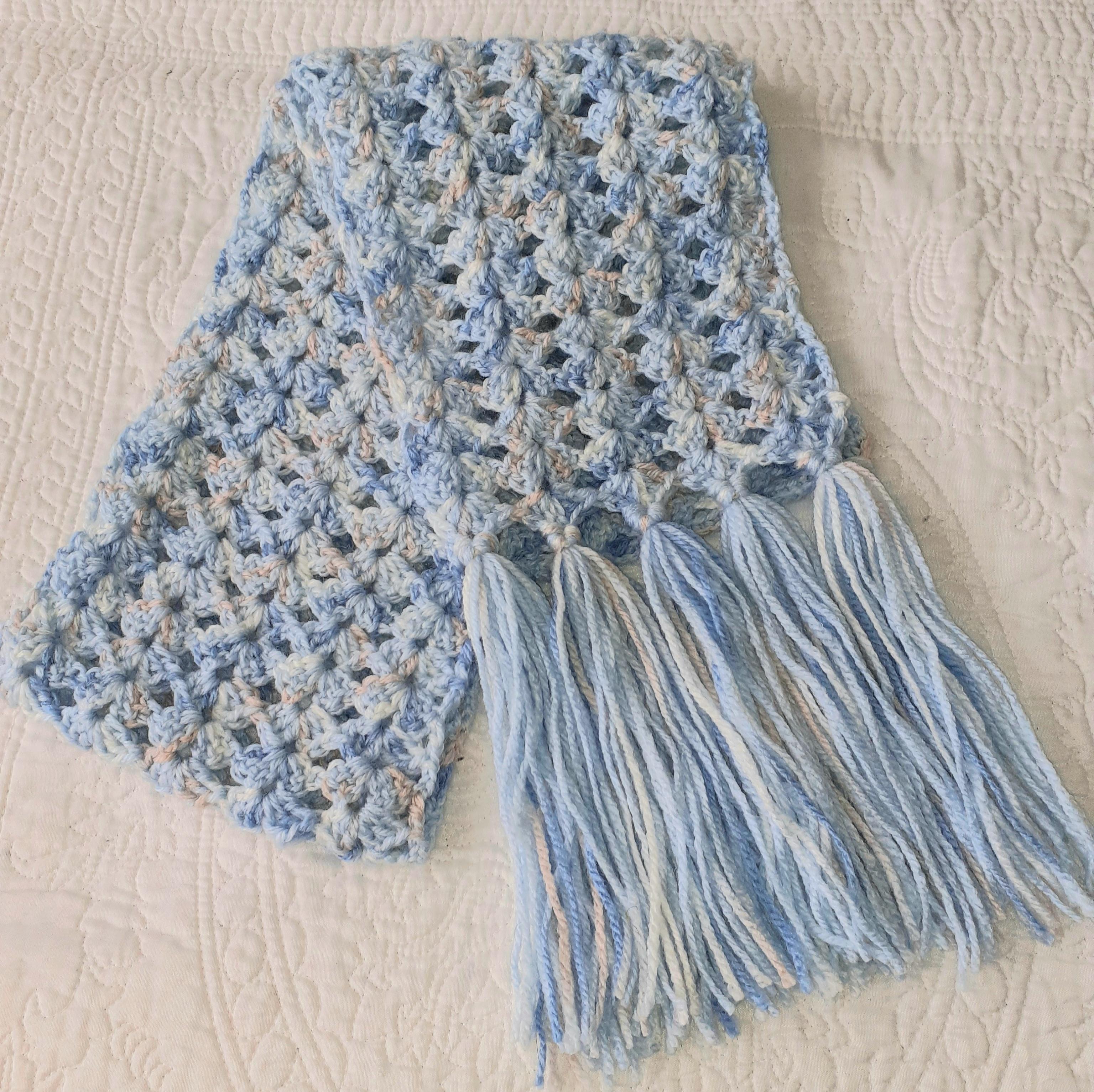 Pretty medium weight scarf in lacy design with shades of blue and apricot.  Stand out this winter!  Unique and handmade with love x